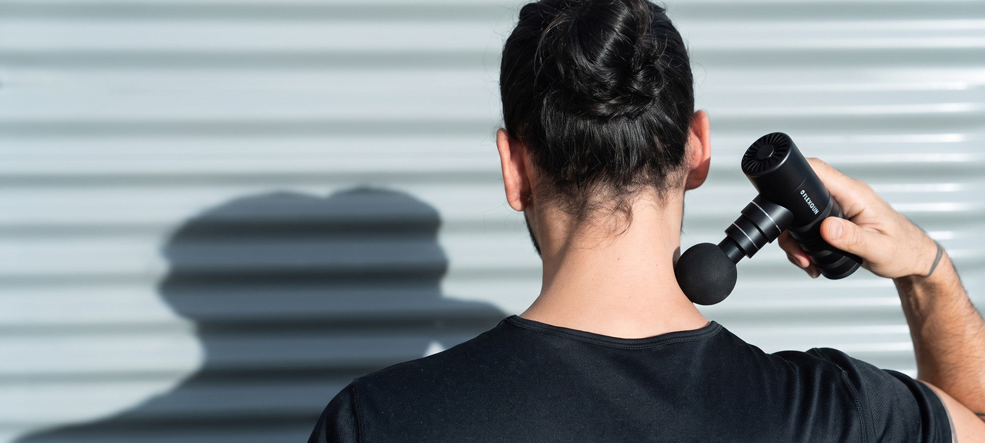 Flexgun mini massage gun on neck and shoulders